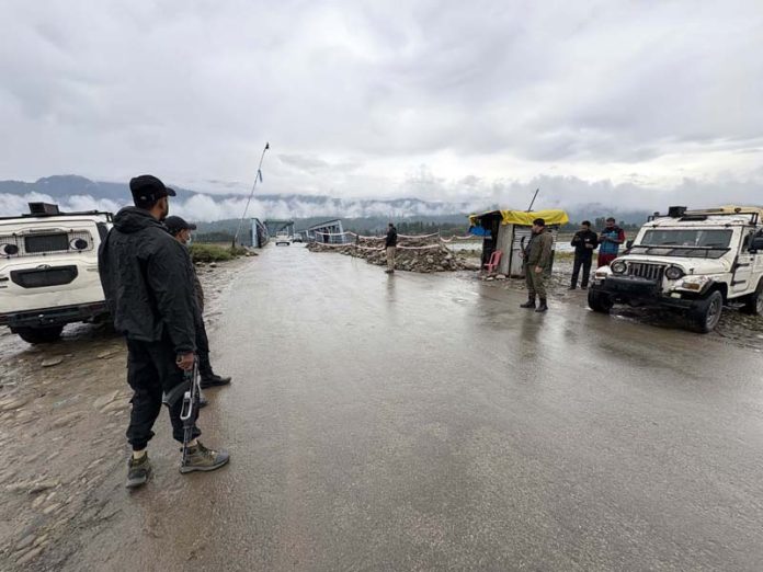 Security personnel at the site of encounter at Guddar, Kulgam on Monday. -Excelsior/Sajad Dar Security personnel at the site of encounter at Guddar, Kulgam on Monday. -Excelsior/Sajad Dar