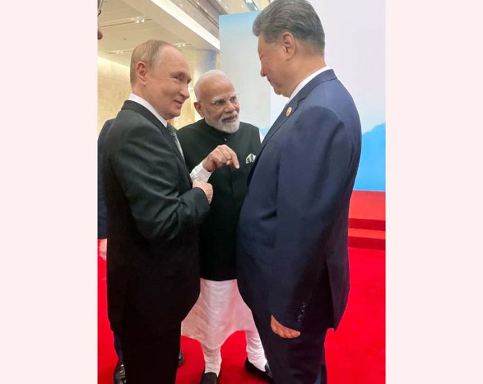 Prime Minister Narendra Modi with Russian President Vladimir Putin and Chinese President Xi Jinping share a moment of interaction on the sidelines of the 25th SCO Heads of State Council Summit, in China on Monday. (UNI)