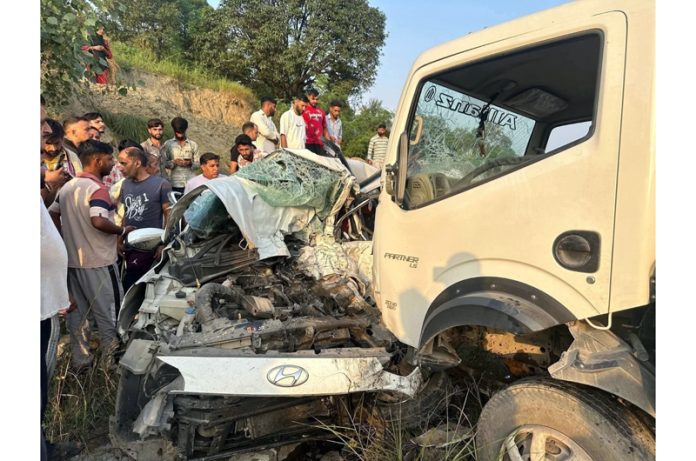 A car turns into wreckage after collision with a crane in Chowki Choura area near Bhamla on Jammu-Rajouri Road on Sunday. -Excelsior/Imran