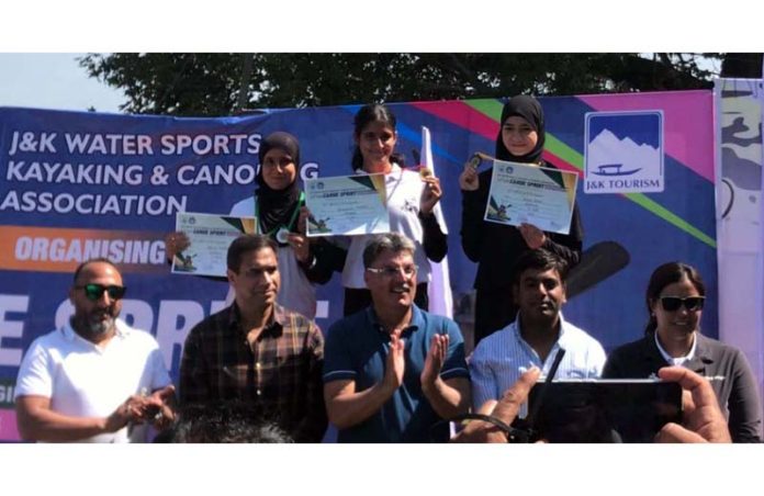 Medal winners posing along with dignitaries.