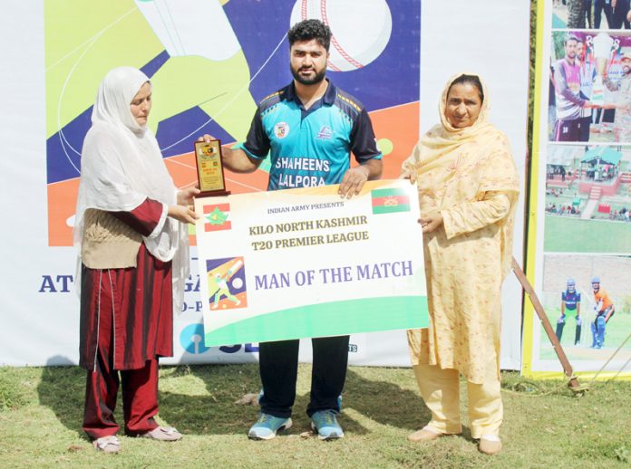 Player of the match receiving trophy and cheque during post match presentation.