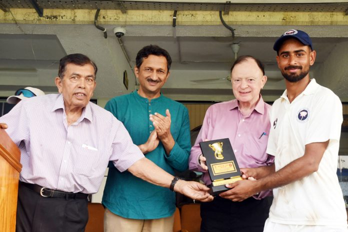 Man of the match receiving memento from dignitaries. Man of the match receiving memento from dignitaries.