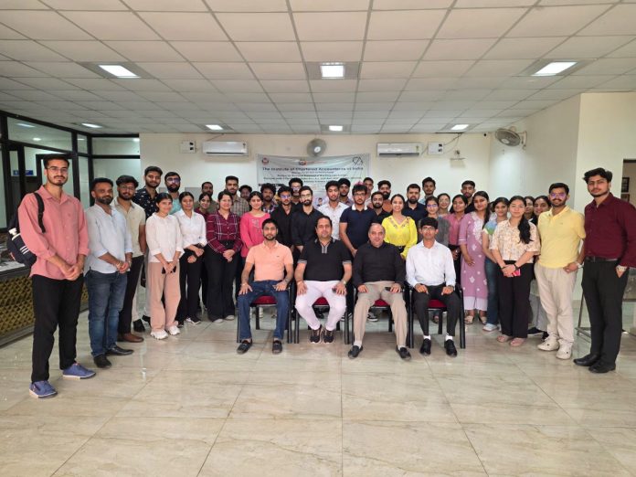 Dignitaries posing along with participating students during a programme.