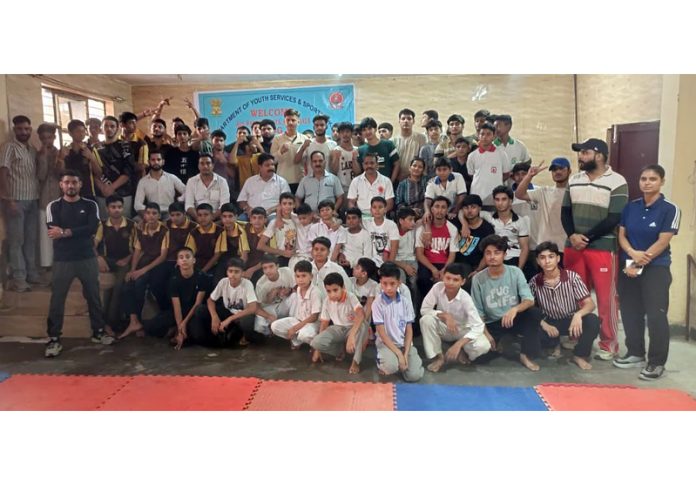 Winners in various categories of Kurash Championship posing along with guests and officials.