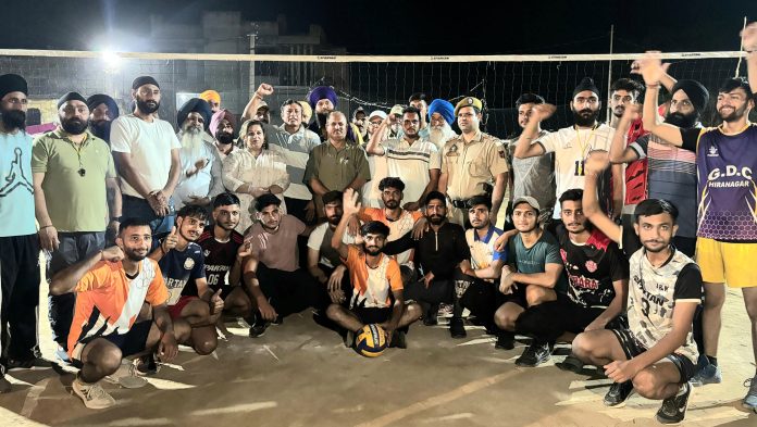 Dignitary posing along with Volleyball players.