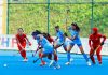 Players in action during a hockey match between India and Singapore.