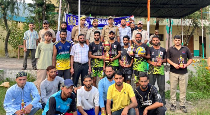 Winning team posing alongside police officers with trophy. -Excelsior/Imran Winning team posing alongside police officers with trophy. -Excelsior/Imran