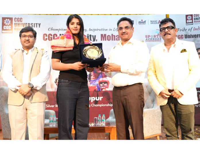 Boxing Champion Nupur receiving memento from University Management. Boxing Champion Nupur receiving memento from University Management.