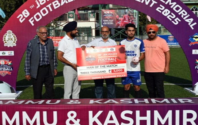 Player of the match receiving cheque from dignitaries.