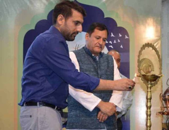 Minister Javid Dar lighting a lamp during Himayat Alumni Meet at Srinagar on Thursday.