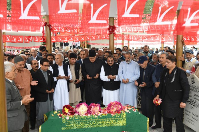 Dr Farooq Abdullah along with others offering floral tribute to Sheikh Muhammad Abdullah in Srinagar. — Excelsior/Shakeel