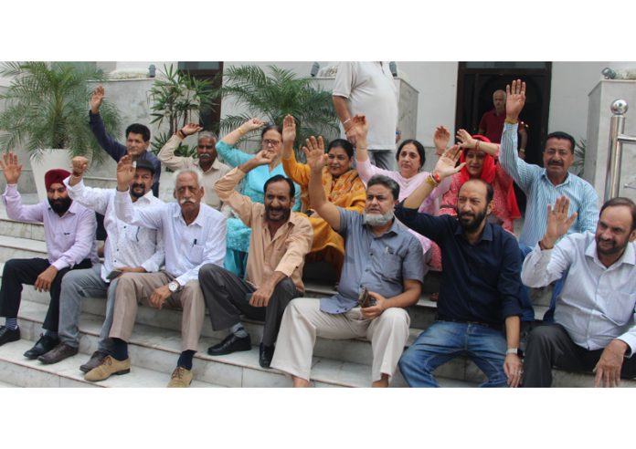 JKTDC retired employees raising slogans during a protest in Jammu on Monday. JKTDC retired employees raising slogans during a protest in Jammu on Monday.