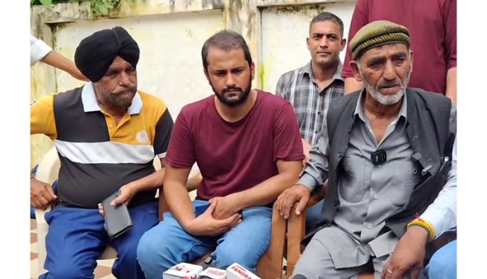 AAP MLA Mehraj Malik’s father talking to media persons at Jammu on Thursday.