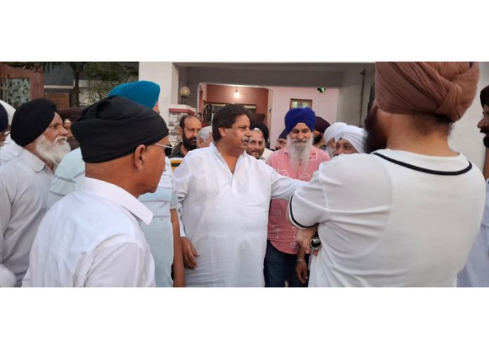 Senior Cong leader Raman Bhalla interacting with people in RS Pura on Tuesday.
