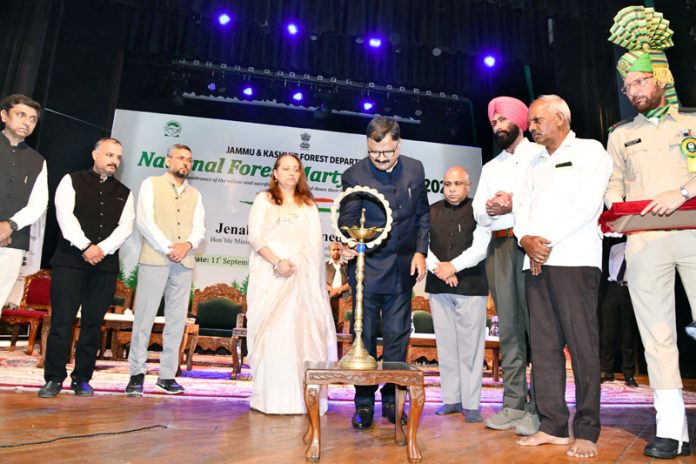 Minister Javed Ahmad Rana lighting lamp during National Forest Martyrs’ Day at Srinagar on Thursday.
