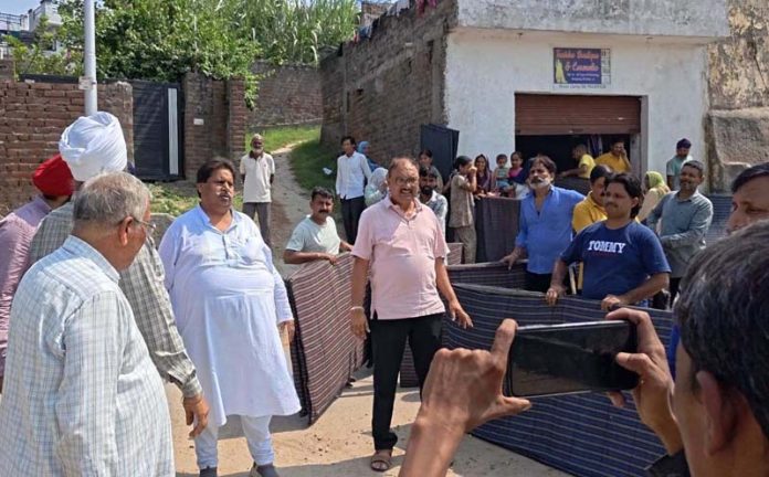 Senior Cong leader, Raman Bhalla interacting with flood hit people of Bhour Camp in Jammu South.