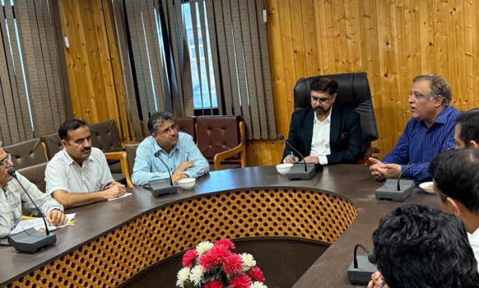 Minister Satish Sharma chairing a meeting.