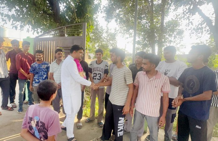 AICC Secy Neeraj Kundan interacting with youth at Kathav village in Bishnah.