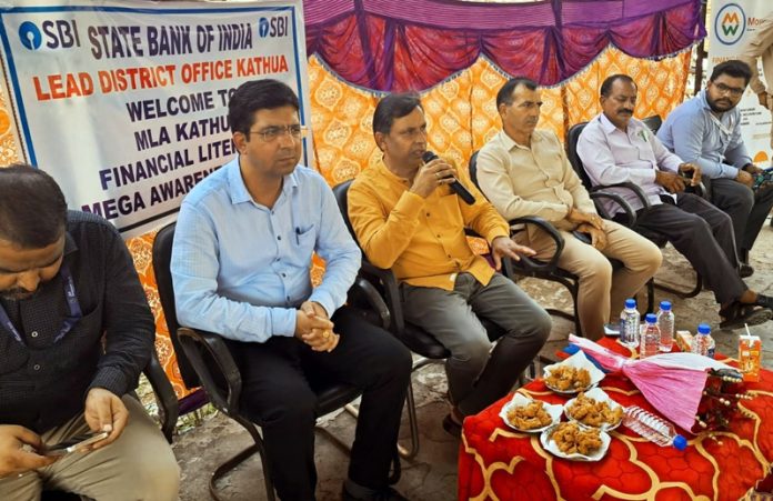 MLA Kathua, Dr Bharat Bushan along with bankers at an awareness camp at village Khokhyal in Kathua on Sunday.