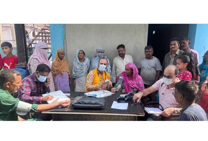HoD Cardiology GMC&SSH Jammu Dr Sushil Sharma examining patients at Rajeev Colony on Sunday.
