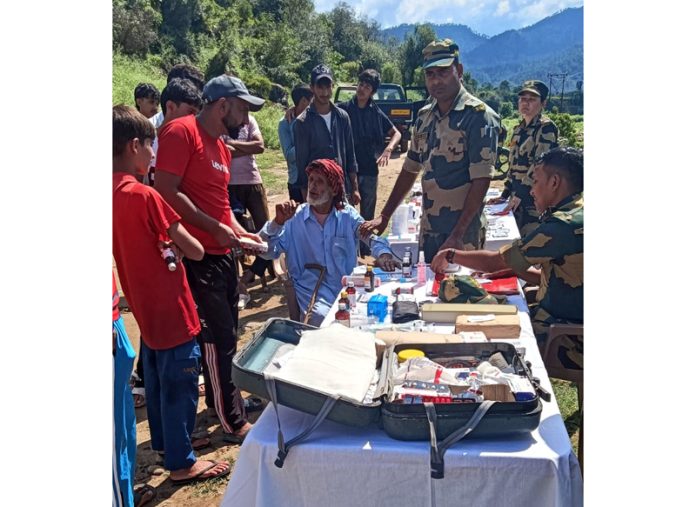 A team of doctors examining people during a medical camp organized by BSF.