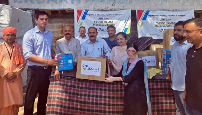 MLA Jammu East, Yudhvir Sethi and DC Jammu, Dr Rakesh Minhas distributing relief material among flood hit people on Friday.