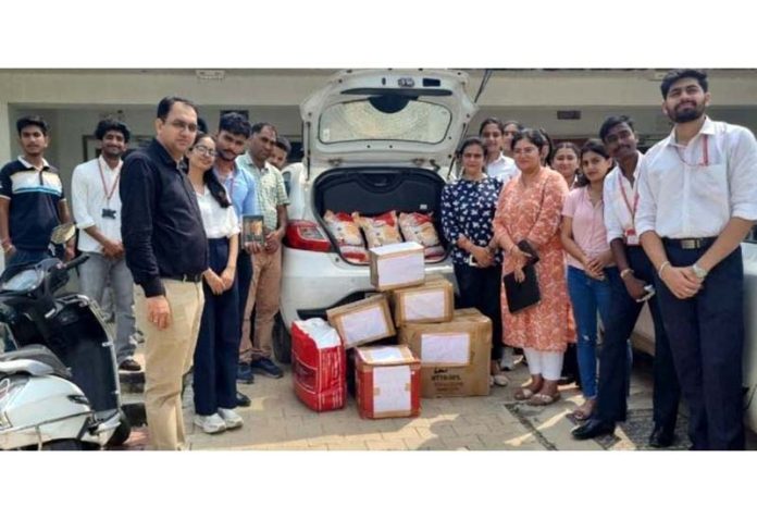 CUJ students handing over relief material to Red Cross Society.