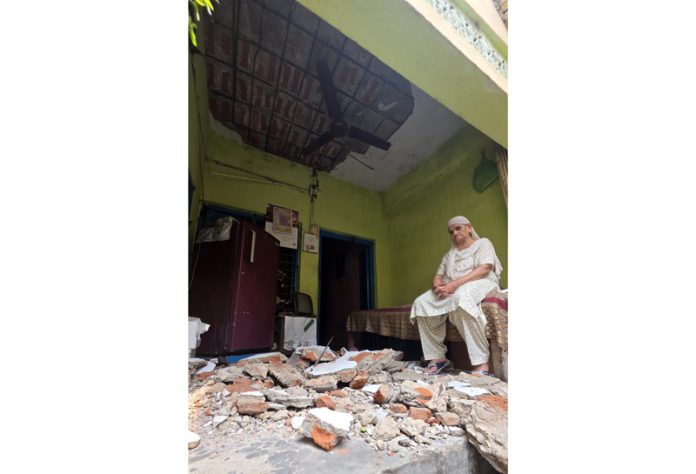 An elderly lady sitting in her house in Shakti Nagar area of Jammu after ceiling of the house collapsed. -Excelsior/Rakesh