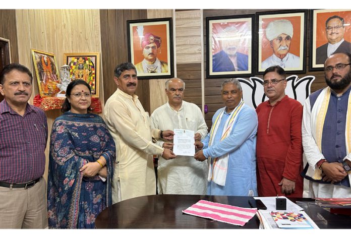 MP Jugal Kishore Sharma handing over a letter of enhancing MPLADS contribution to Rs 2.5 crore to BJP leaders at Party Headquarters Jammu on Saturday.