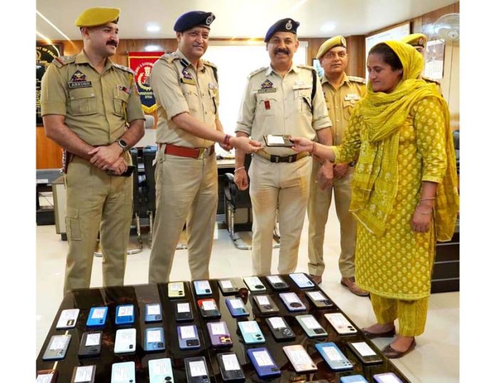 SSP Sandeep Mehta handing over recovered phones to their owners in Doda. -Excelsior/Tilak Raj