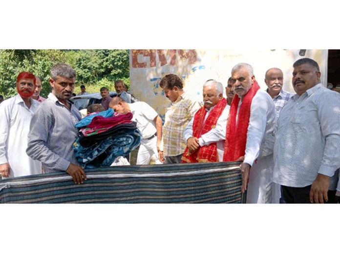 Senior NC leader Ajay Kumar Sadhotra distributing relief to victims of rains and floods at village Kangar in Jammu. Senior NC leader Ajay Kumar Sadhotra distributing relief to victims of rains and floods at village Kangar in Jammu.