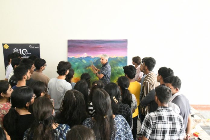 Students of IIM Jammu witnessing creativity unfolding in real time as K K Gandhi paints before their eyes.