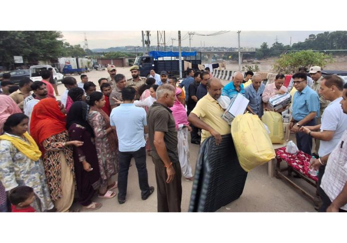 CGPWA members along with officers from District Administration distributing relief to the flood victims in Jammu on Monday. CGPWA members along with officers from District Administration distributing relief to the flood victims in Jammu on Monday.