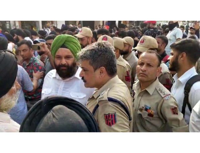 SP North, Vivek Shekhar, trying to pacify the protestors outside SPMR Commerce College in Jammu on Thursday.