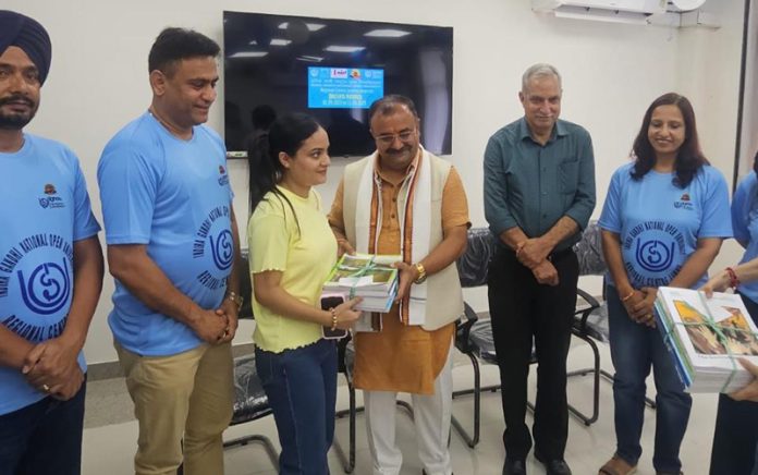 MLA Vikram Randhawa giving study material to an IGNOU student at its Regional Centre Jammu on Friday.