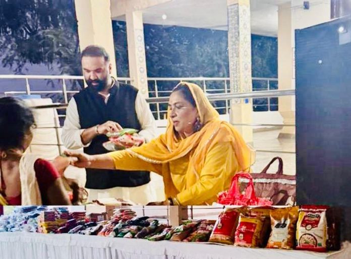 Dr Ritu Singh and Ranvijay Singh distributing relief material among rain-affected families at Dhonthali Takki in Jammu.