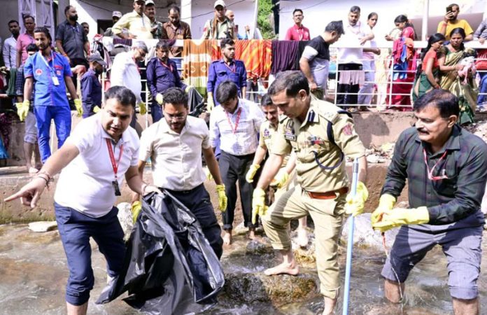 Officers during cleanliness drive at Banganga.