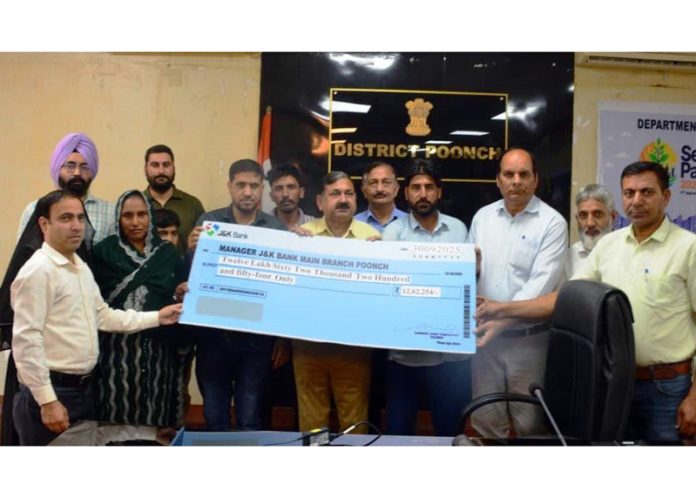 DC Poonch Ashok Kumar Sharma disbursing amount among registered construction workers on Tuesday.