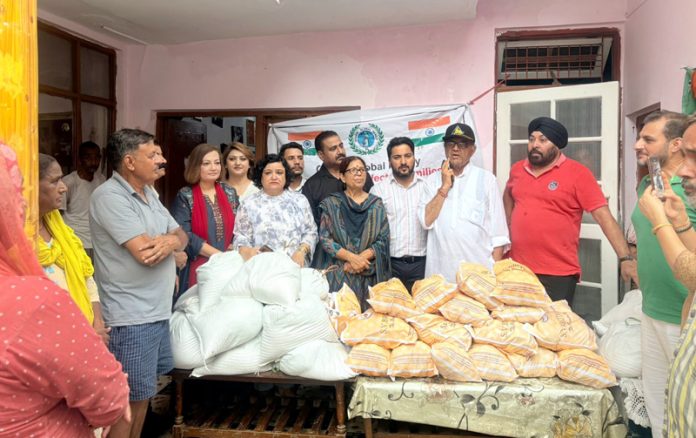 GGF members distributing relief material to flood hit people in Jammu on Sunday.