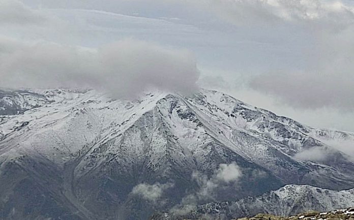 The ski resort of Gulmarg received its first snowfall of the season with the Afarwat peak draped in white, in Baramulla on Friday.