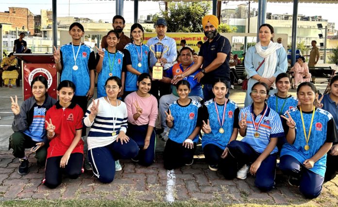 Winning team posing along with trophy during prize distribution ceremony.