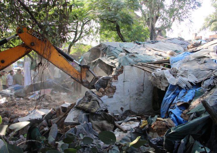 A JCB demolishing an illegal structure during an anti-encroachment drive at Narwal Bypass on Thursday. -Excelsior/Rakesh