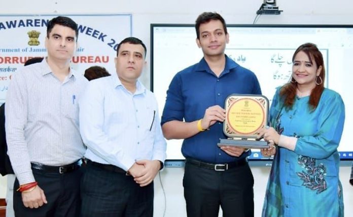 DC Jammu being presented memento by RTI Principal Sunaina Sharma during a function on Monday.