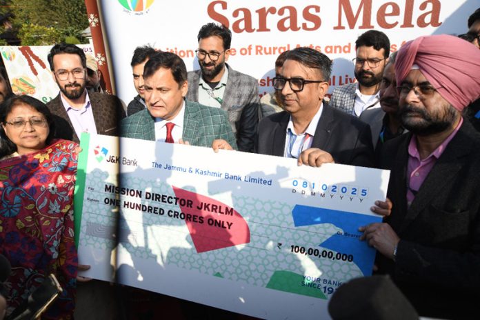 Minister Javid Ahmad Dar receiving symbolic cheque from the officials of J&K Bank and J&K Grameen Bank in Srinagar.