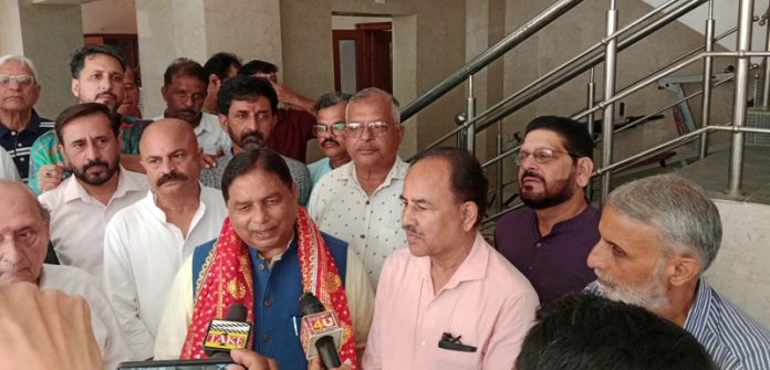 J&K BJP president, Sat Sharma along with others talking with reporters after inaugurating a Physiotherapy Services and Dispensary in Ambphalla, Jammu.