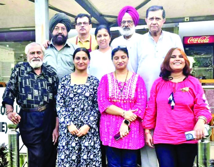 Artists posing for a photograph during the culmination of a painters' camp in Mansar.
