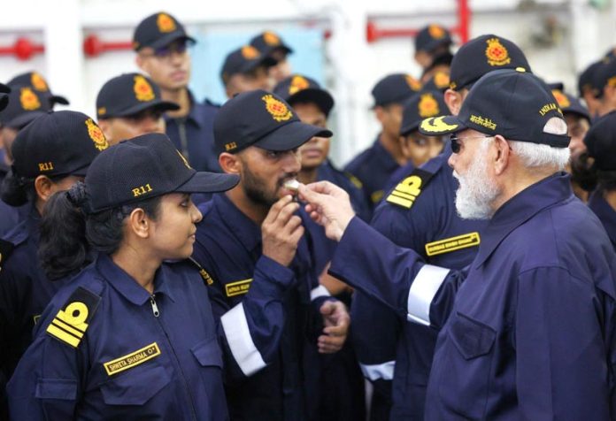 Prime Minister Narendra Modi offers sweets to Navy personnel as he celebrates Diwali festival on board INS Vikrant, in Panaji on Monday. (UNI)