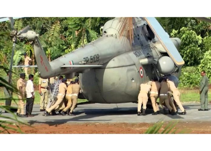 Visuals showing police and fire force personnel physically pushing the helicopter carrying President Droupadi Murmu, which partially sank into an unset concrete helipad shortly after landing, moments after she had safely alighted, at the Pramadom Indoor Stadium, Kerala on Wednesday. (UNI) Visuals showing police and fire force personnel physically pushing the helicopter carrying President Droupadi Murmu, which partially sank into an unset concrete helipad shortly after landing, moments after she had safely alighted, at the Pramadom Indoor Stadium, Kerala on Wednesday. (UNI)