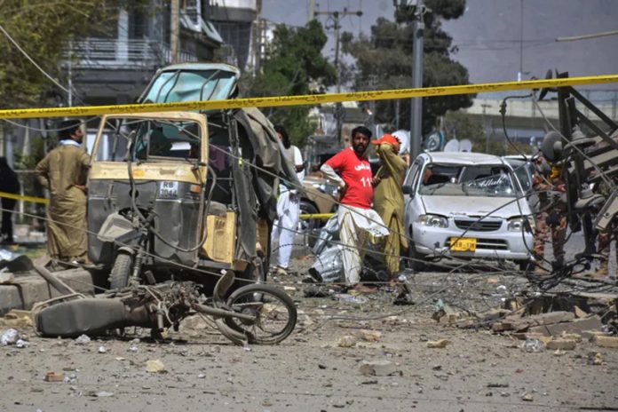 Rescue workers and security officials examine damaged vehicles at the site of a powerful car bombing in Quetta, Pakistan on Tuesday.