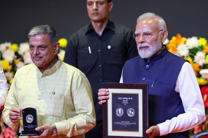 page1-3-1 Prime Minister Narendra Modi releasing a commemorative coin at the centenary celebrations of the RSS in New Delhi on Wednesday. (UNI)